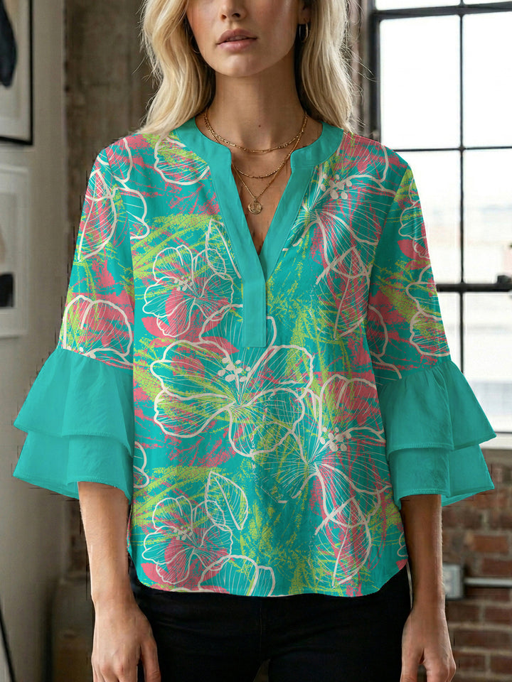 Damebluse med voluminøse ermer og blomsterdesign Skjora