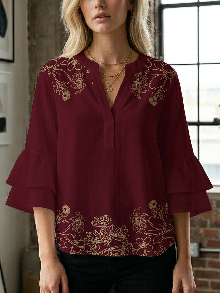 Damebluse med voluminøse volangermer og floral trykk Skjora