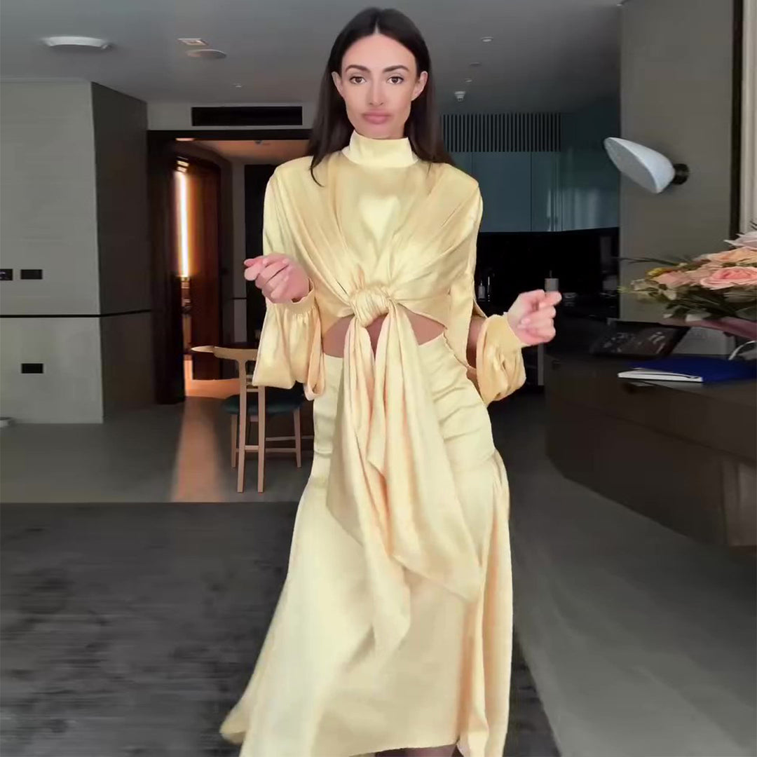 Kvinnes elegant omslagskjole med fashionable utskjæringsdetaljer og voluminøse ermer Skjora