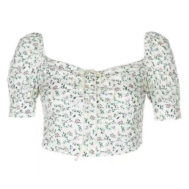 Kvinnes crop top med puffermer og blomsterdesign