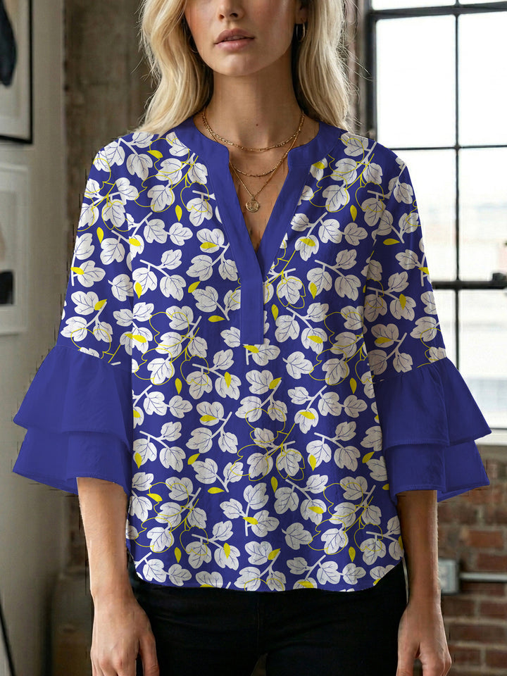Damebluse med voluminøse ermer og blomsterdesign Skjora