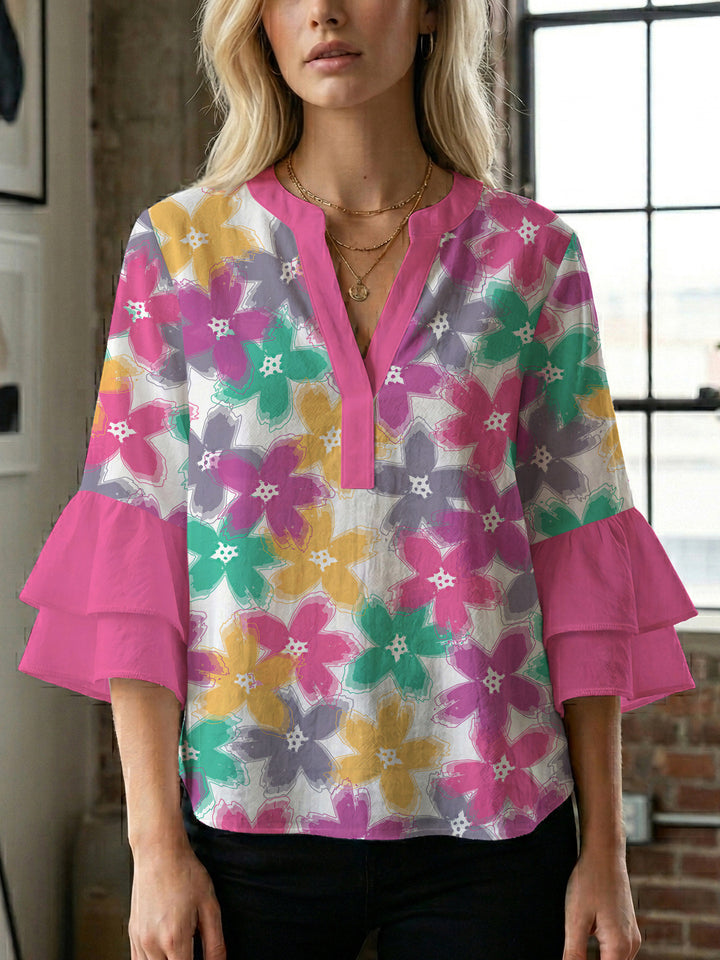 Damebluse med voluminøse ermer og blomsterdesign Skjora