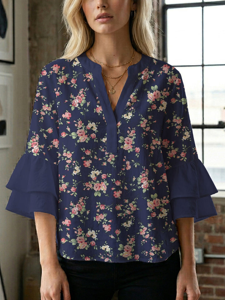 Damebluse med voluminøse ermer og blomsterdesign Skjora