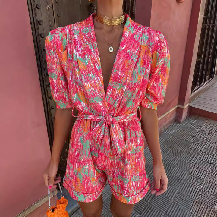 Kvinnelig Elegant Jumpsuit med Dyp V-Hals og Knappbar Belte Skjora