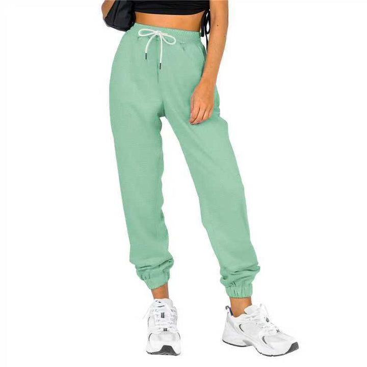 Kvinne sporty joggebukser med praktisk snor og elastisk liv.
