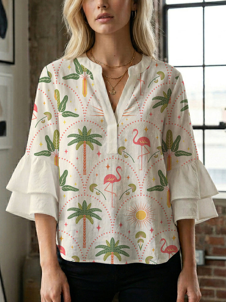 Damebluse med voluminøse volangermer og floral trykk Skjora