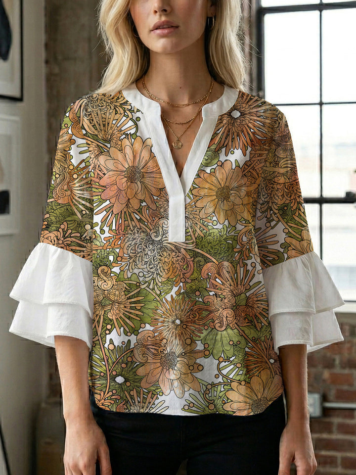 Damebluse med voluminøse puffermer og kreativt blomstermønster Skjora