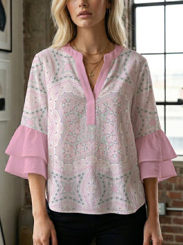 Damebluse med voluminøse puffermer og kreativt blomstermønster Skjora