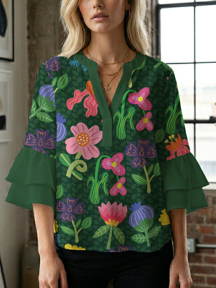 Damebluse med voluminøse ermer og blomsterdesign Skjora