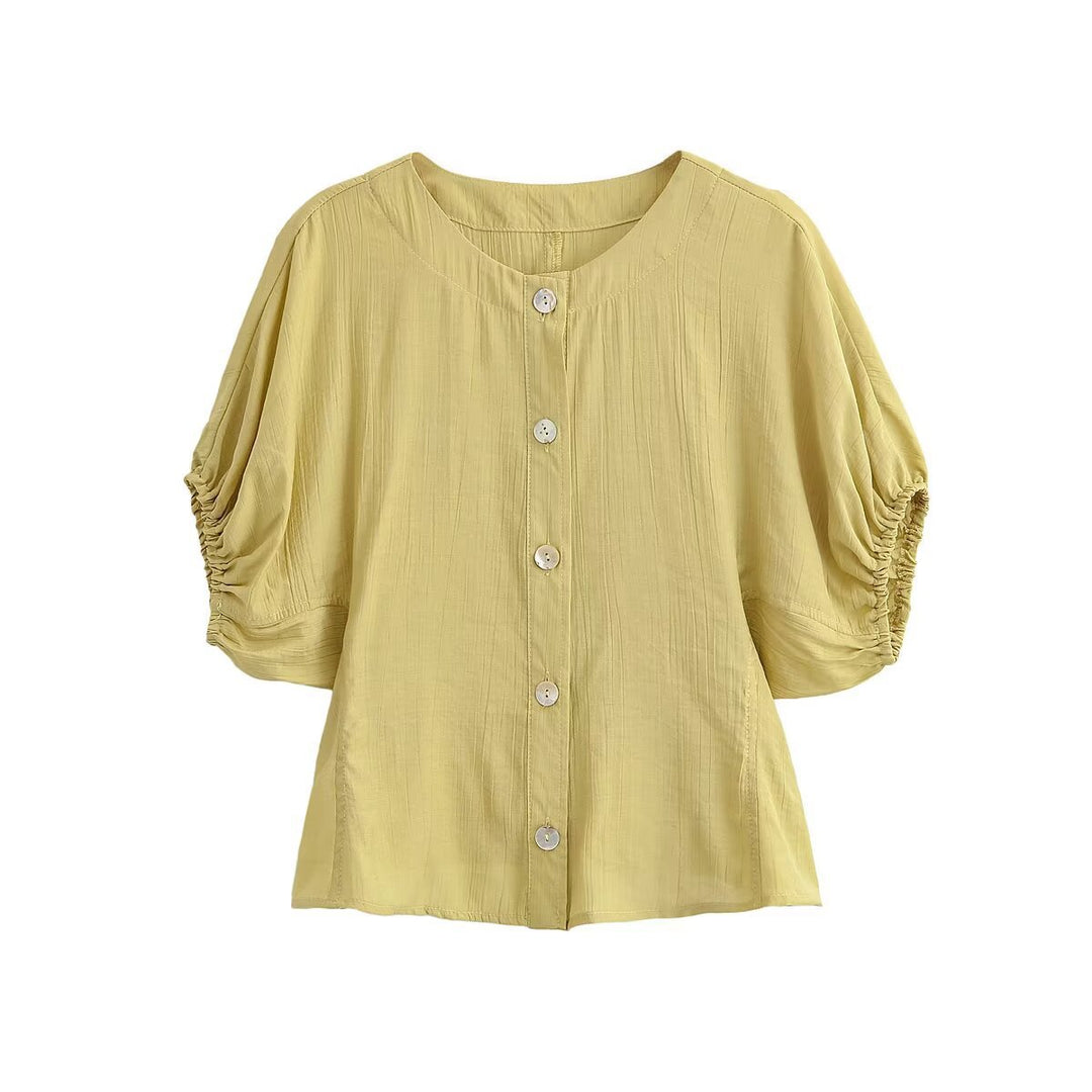 Damebluse med pufferm og dekorative knapper Skjora