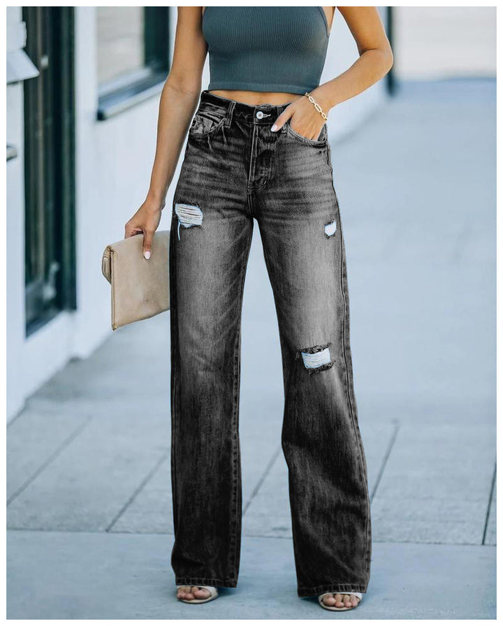 Kvinnelige vidde jeans med slitte effekter og høy liv