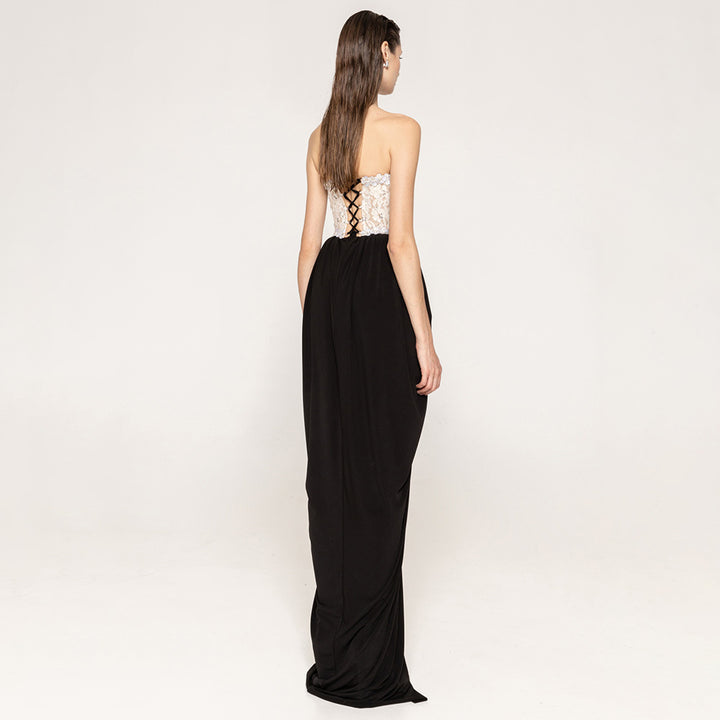 Women's elegant evening dress with glittery pointed top and draped skirt