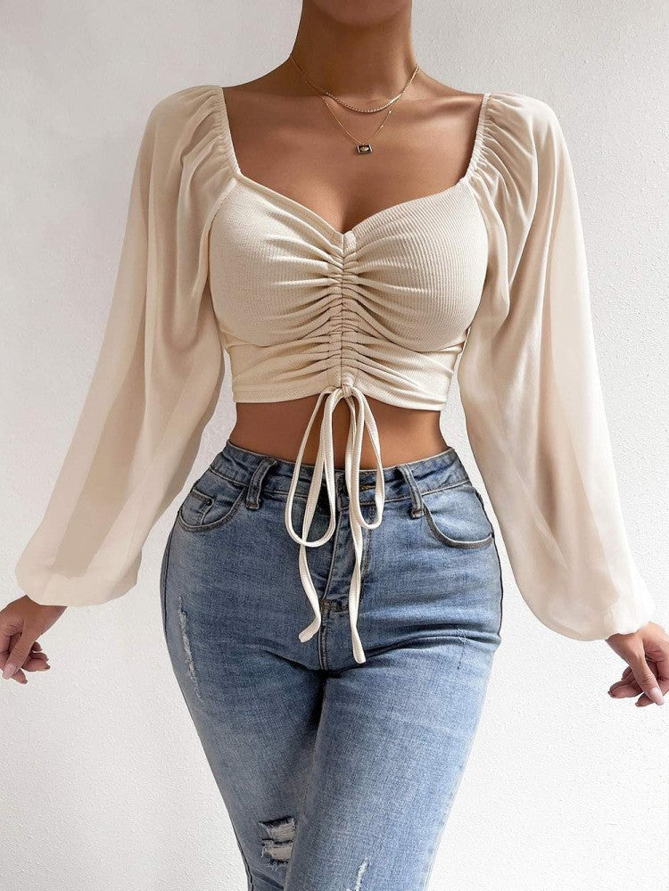 Dame Crop-Top med strukturert kropp og elegante pufferm. Skjora
