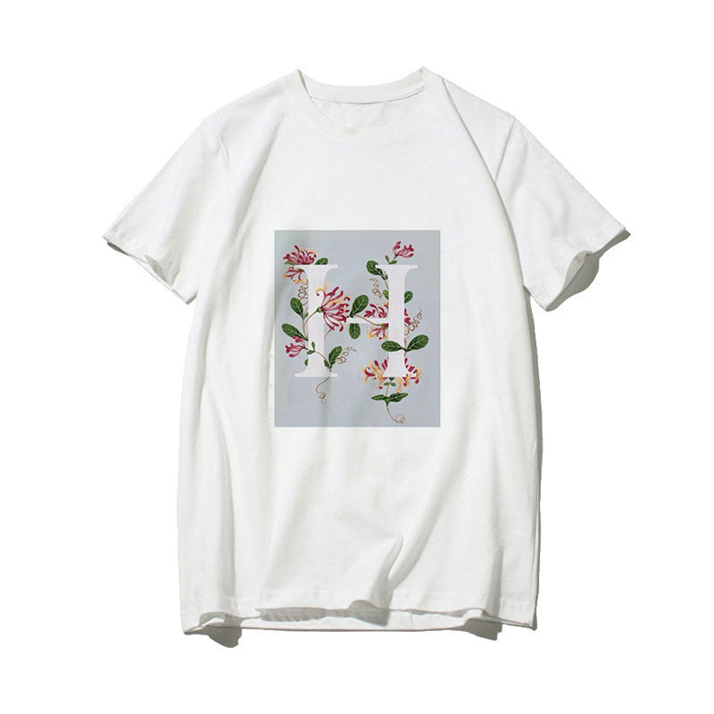 Dame T-skjorte med blomsterdesign og kreativt trykk Skjora