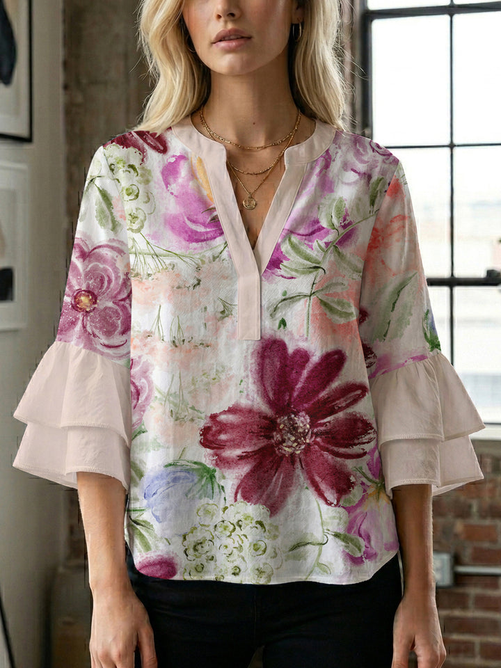 Damebluse med voluminøse ermer og blomsterdesign Skjora