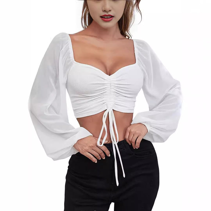 Dame Crop-Top med strukturert kropp og elegante pufferm. Skjora