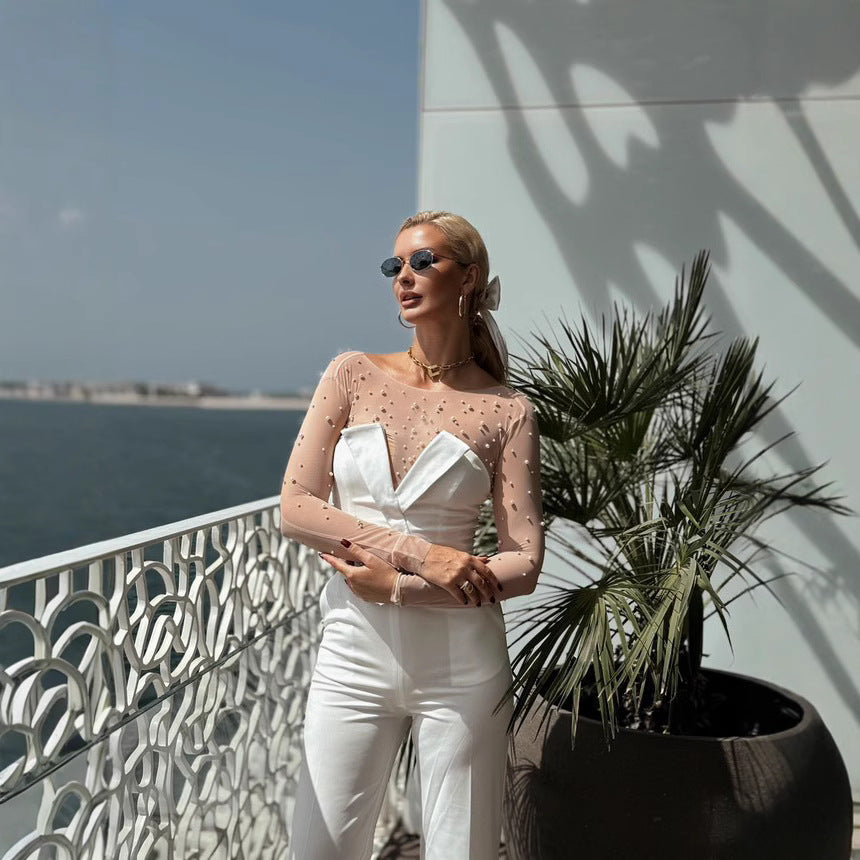 Damer elegant jumpsuit med transparente ermer og perlepynt Skjora