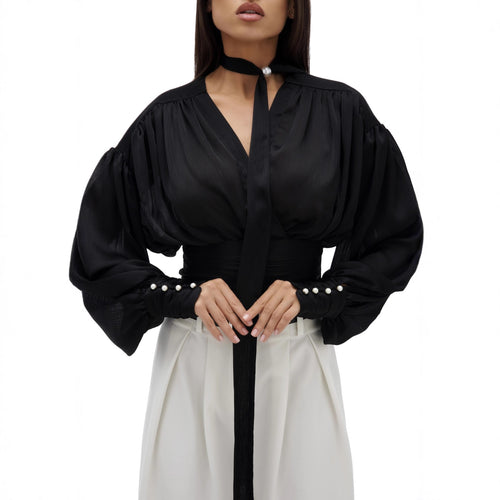 Kvinnebluse med voluminøse ermer og elegante perleknapper Skjora
