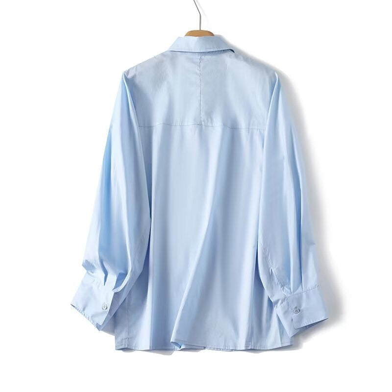Dame elegant langermet bluse med moderne detaljer og strukturert stoff Skjora