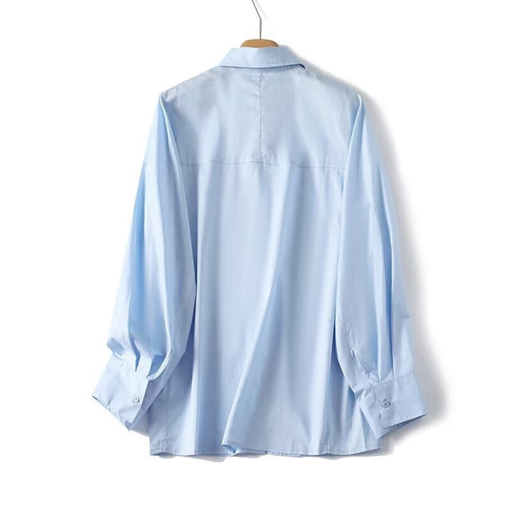 Dame elegant langermet bluse med moderne detaljer og strukturert stoff Skjora