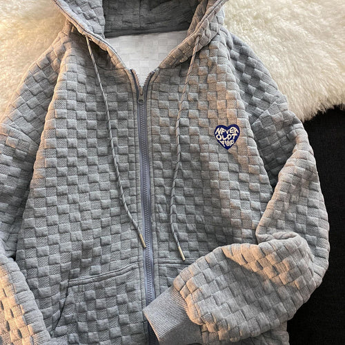 Dame hoodie-jakke laget av strukturelt materiale med praktiske lommer og fashionable design