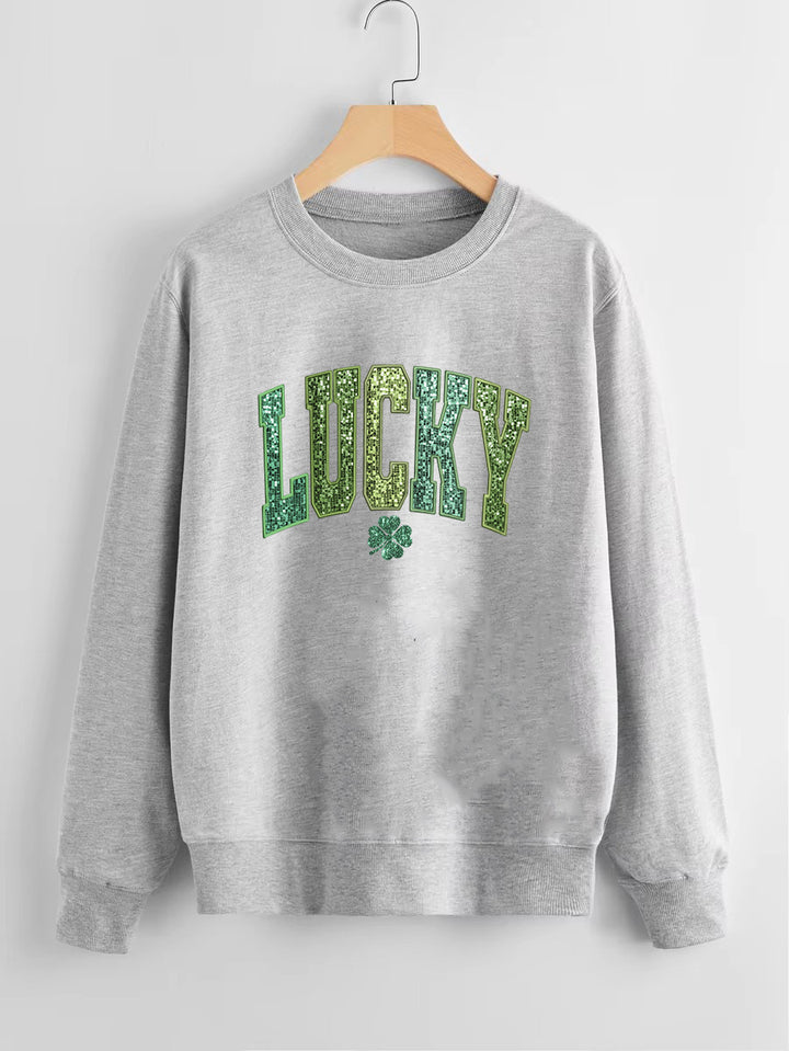 Dame uformell sweatshirt med glitrende skrift og firkløvermotiv Skjora