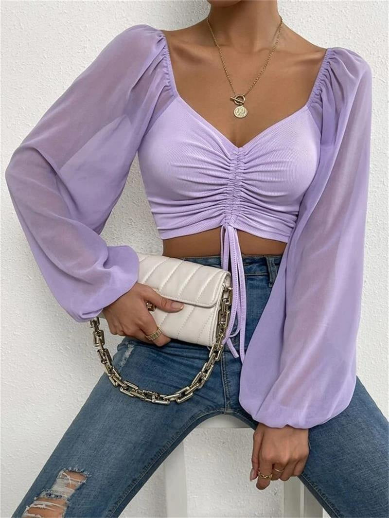 Dame Crop-Top med strukturert kropp og elegante pufferm. Skjora