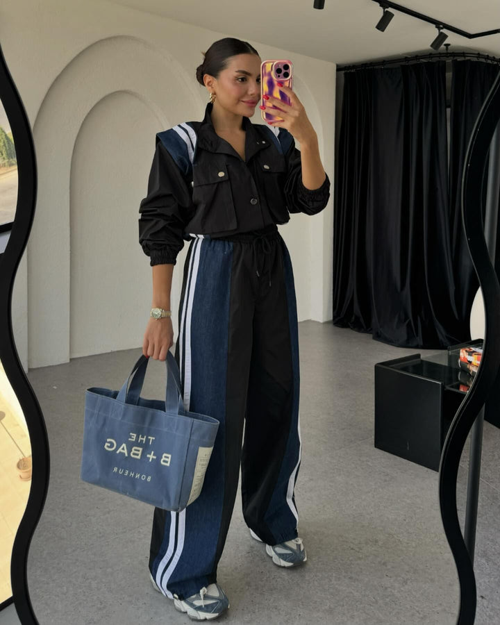 Women's sporty jumpsuit with sophisticated drawstring detail at the waist and contrasting stripes on the skirt