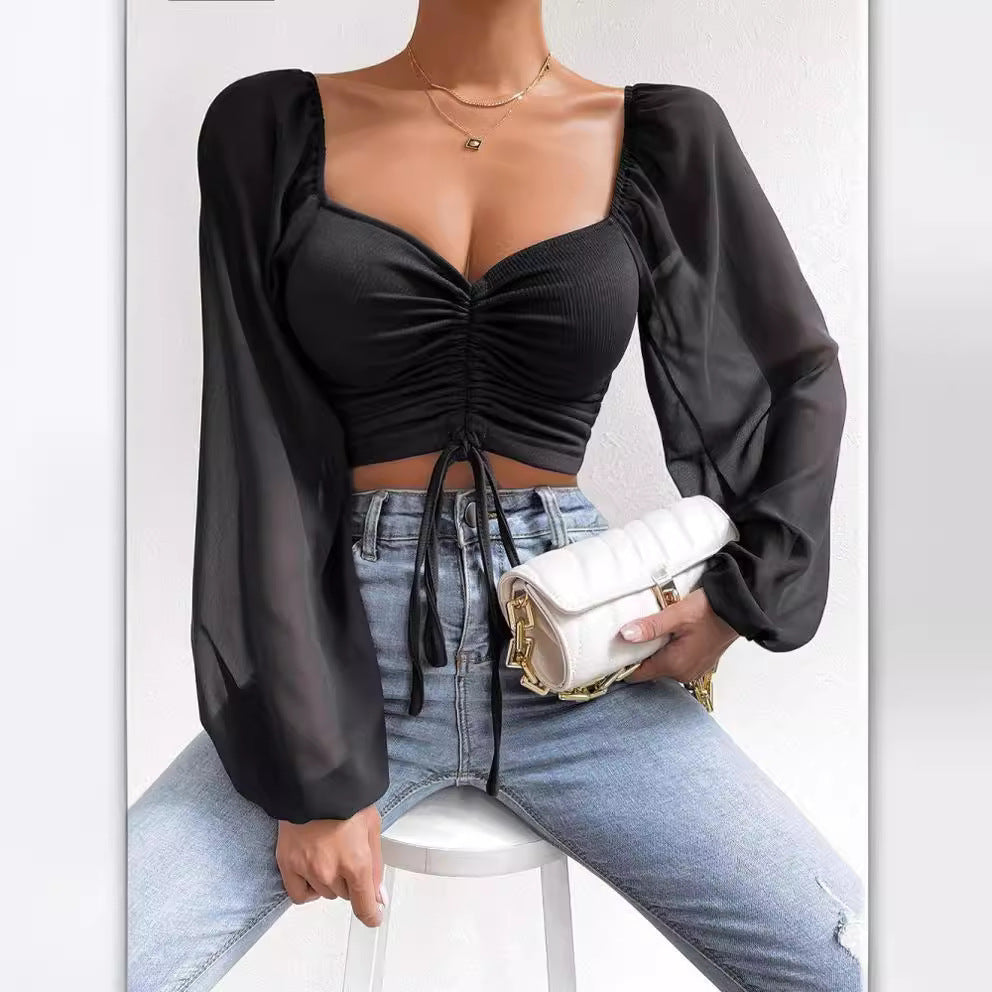 Dame Crop-Top med strukturert kropp og elegante pufferm. Skjora