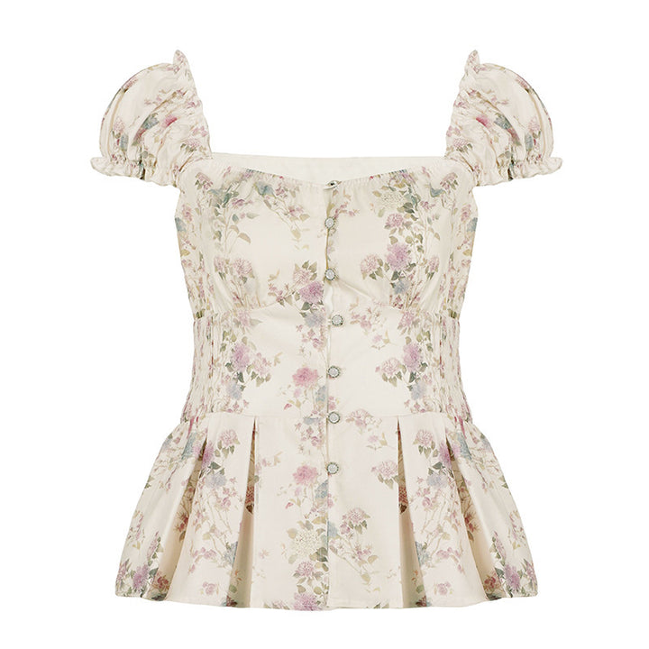 Damebluse med blomsterdesign og volanger