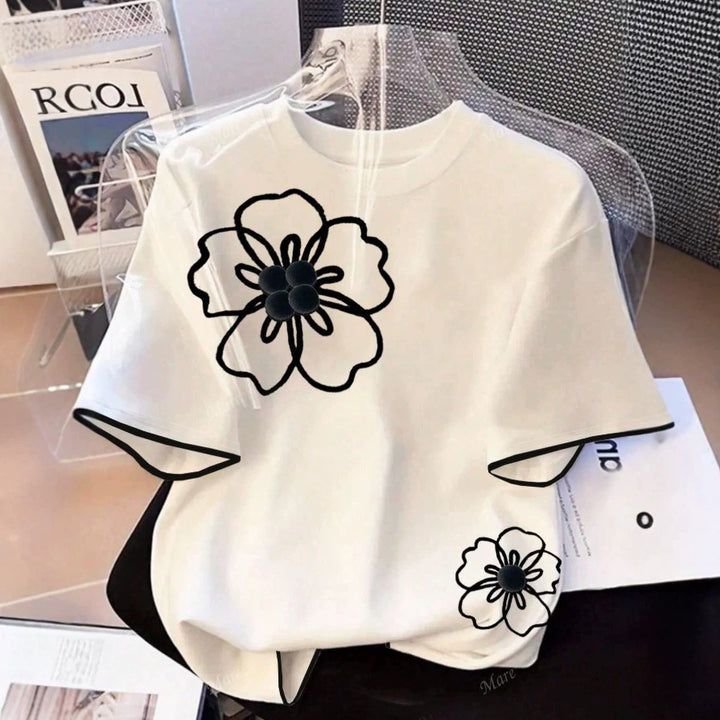 Dame T-skjorte med blomstret design og løs passform Skjora