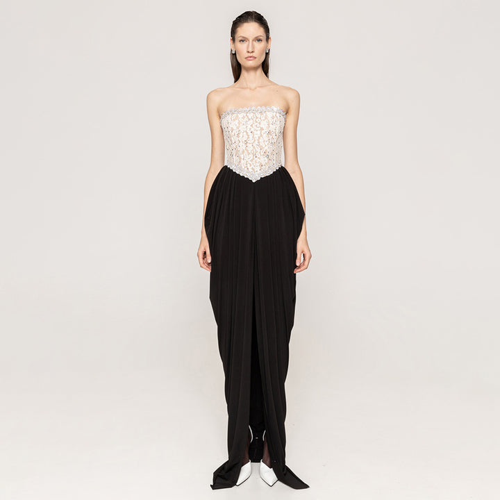 Women's elegant evening dress with glittery pointed top and draped skirt