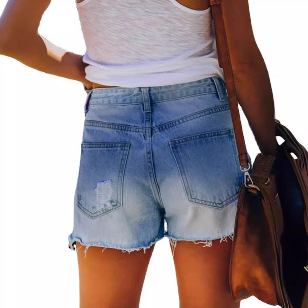 Damejeansshorts med moteriktig stjerneprint og slitte detaljer Skjora