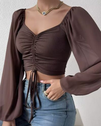 Dame Crop-Top med strukturert kropp og elegante pufferm. Skjora