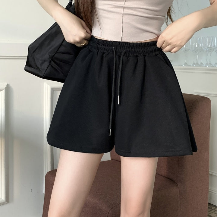 Kvinnens komfortable sweat shortser med elastisk midje og avslappet snitt