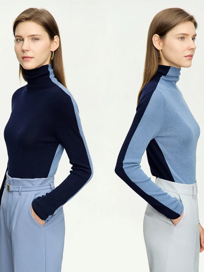 Side by side pictures of a woman wearing the same dual toned blue and dark blue sweater showcasing the interchangeable feature to achieve 2 looks with one sweater.